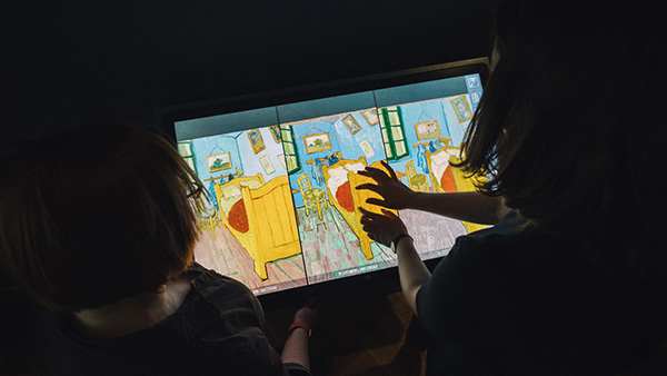 Visitors pinch, zoom, and pan across the three "Bedroom" paintings using the conservation lab touchscreen kiosk at the Art Institute of Chicago. 