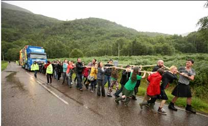 Fellow Travellers pull the bus on A Pilgrimage. Photo by The Guardian